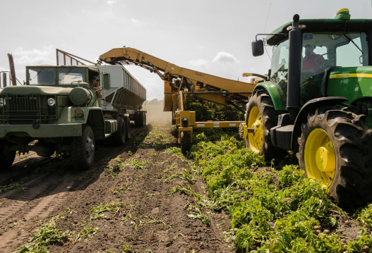 Modern farming equipment harvesting crops in a field