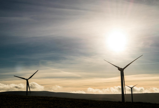 Wind turbines on a landscape during sunset